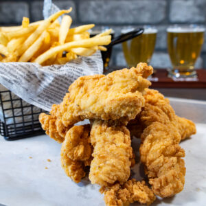 Chicken Strips with basket of fires and beer flight