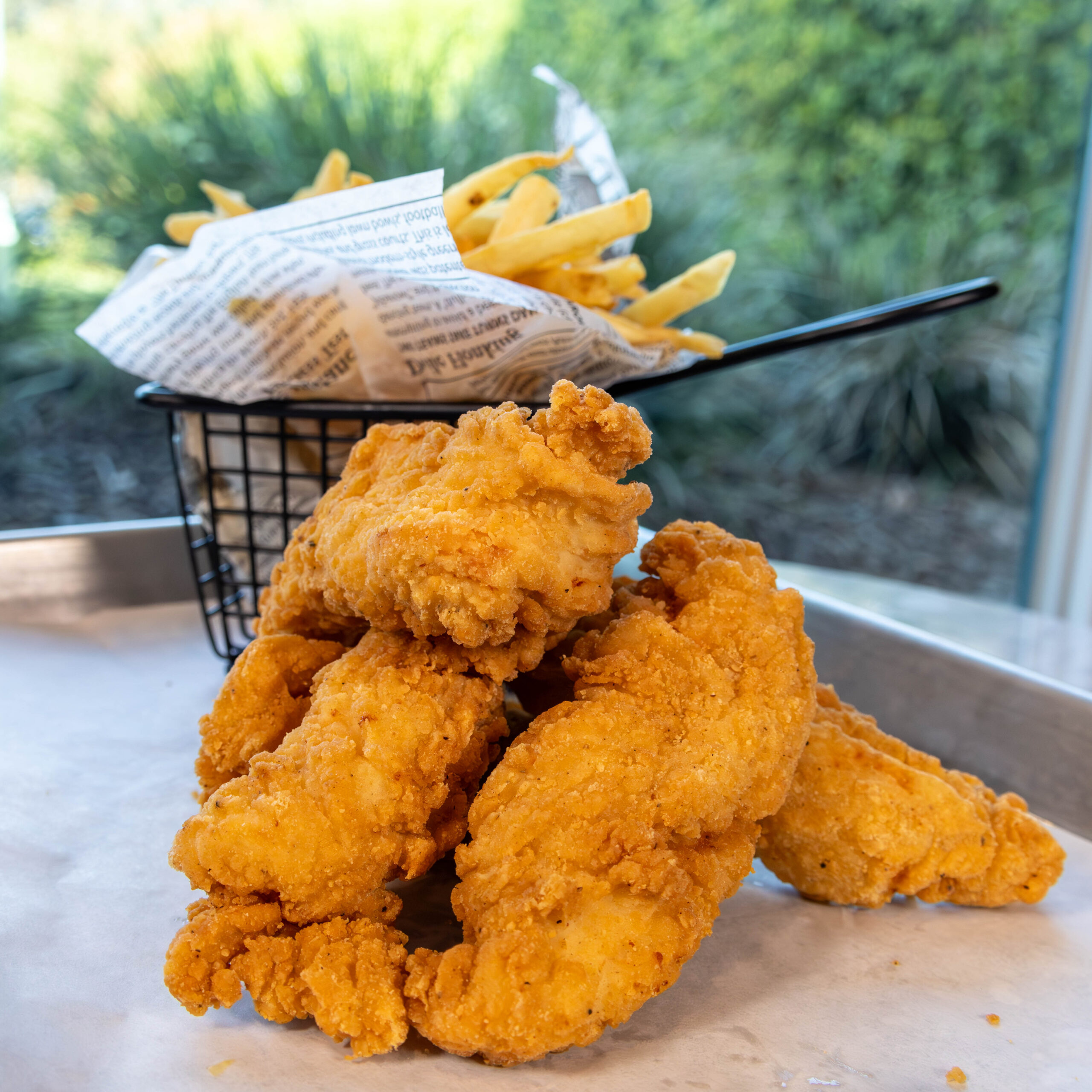 Chicken tenders with basket of fries